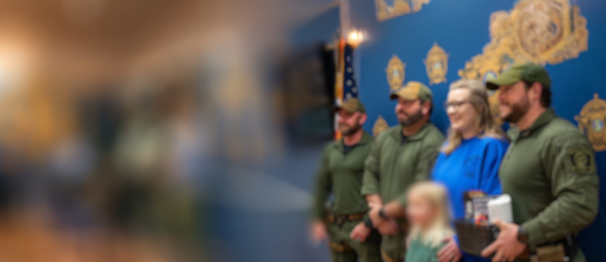 Image of blue crew presenting care package to leos